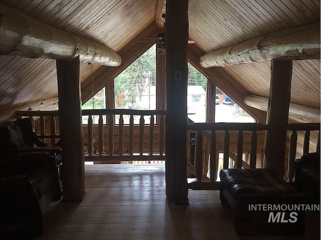 exterior space with lofted ceiling with beams, dark hardwood / wood-style floors, and wooden ceiling