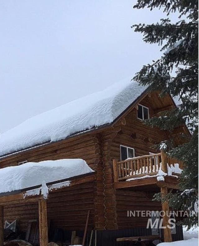 view of snowy exterior with a balcony