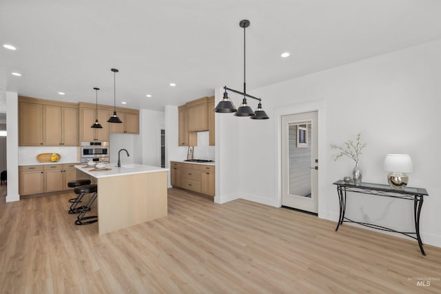 5687 S Snowden Ave, Meridian, ID 83642 - kitchen featuring light countertops, recessed lighting, light wood-type flooring, and appliances with stainless steel finishes