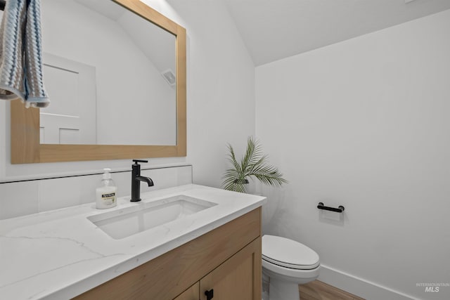 5687 S Snowden Ave, Meridian, ID 83642 - bathroom featuring vanity, wood finished floors, visible vents, baseboards, and toilet