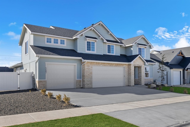 view of front facade featuring fence, roof with shingles, an attached garage, concrete driveway, and stone siding