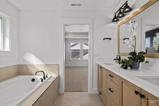 5687 S Snowden Ave, Meridian, ID 83642 - bathroom featuring double vanity, visible vents, a garden tub, and a sink