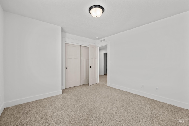 5687 S Snowden Ave, Meridian, ID 83642 - unfurnished bedroom with visible vents, baseboards, light carpet, a closet, and a textured ceiling