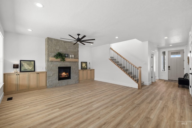 5687 S Snowden Ave, Meridian, ID 83642 - living room with recessed lighting, light wood-type flooring, a fireplace, and stairs