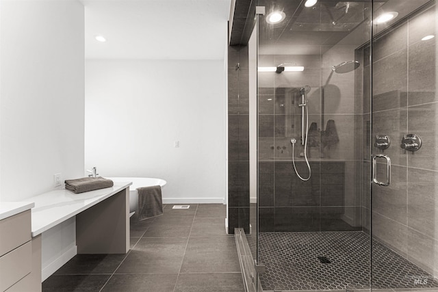 4135 N Hawkeye Pl, Boise, ID 83703 - bathroom with vanity, a stall shower, a freestanding bath, tile patterned flooring, and recessed lighting
