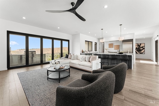 4135 N Hawkeye Pl, Boise, ID 83703 - living room with recessed lighting, ceiling fan, light wood-style flooring, and baseboards