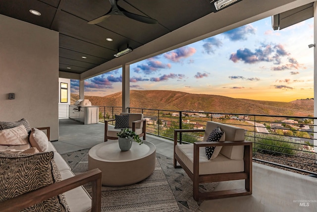 4135 N Hawkeye Pl, Boise, ID 83703 - balcony at dusk featuring a mountain view, outdoor lounge area, ceiling fan, and grilling area