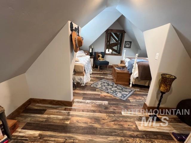 bonus room with hardwood / wood-style flooring and vaulted ceiling