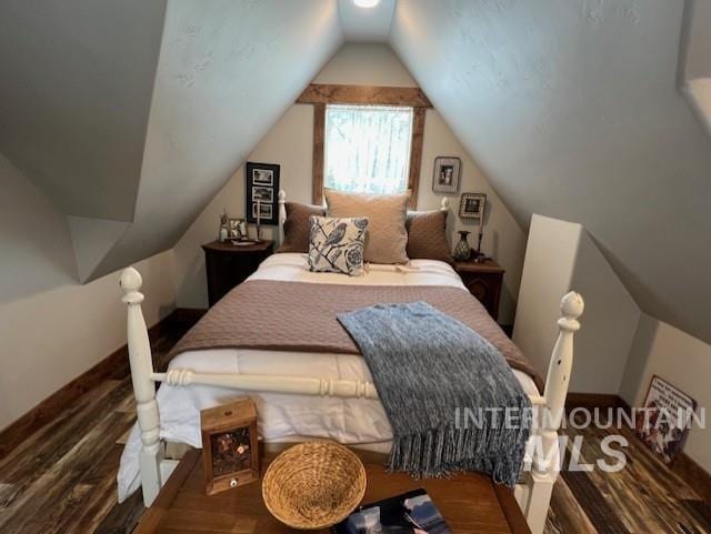 bedroom featuring hardwood / wood-style flooring and lofted ceiling