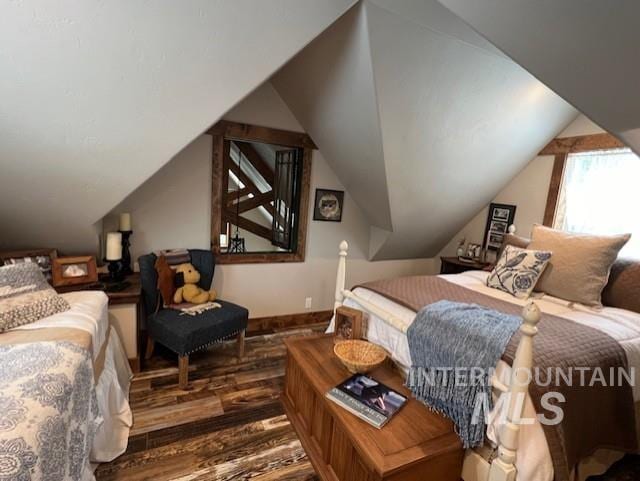 bedroom featuring lofted ceiling and hardwood / wood-style floors