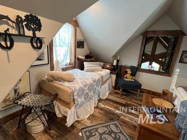 bedroom with wood-type flooring and lofted ceiling