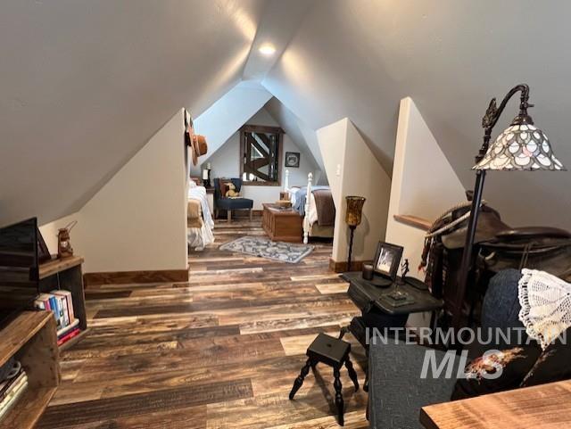 bonus room with vaulted ceiling and hardwood / wood-style floors