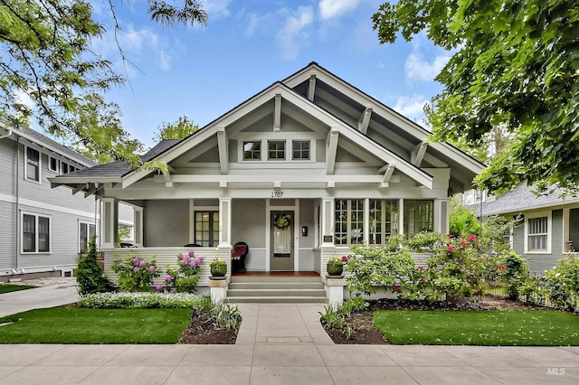 1707 W Resseguie St, Boise, ID 83702 - craftsman-style home with covered porch, stucco siding, and a front yard