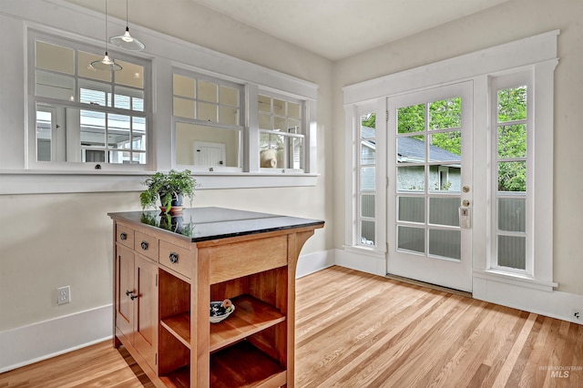 1707 W Resseguie St, Boise, ID 83702 - kitchen with healthy amount of natural light, wood finished floors, pendant lighting, and dark countertops