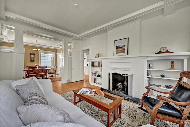 1707 W Resseguie St, Boise, ID 83702 - living area featuring decorative columns, light wood-style flooring, ornamental molding, a chandelier, and a fireplace