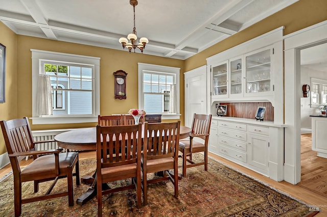 1707 W Resseguie St, Boise, ID 83702 - dining space with coffered ceiling, healthy amount of natural light, wood finished floors, a chandelier, and beam ceiling