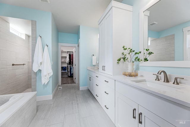 bathroom featuring vanity and a tile shower