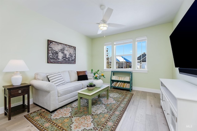 living room with ceiling fan and light wood-type flooring