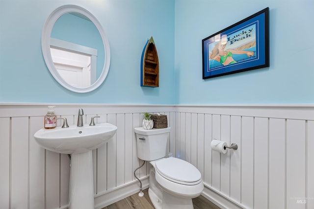 bathroom with sink, hardwood / wood-style floors, and toilet