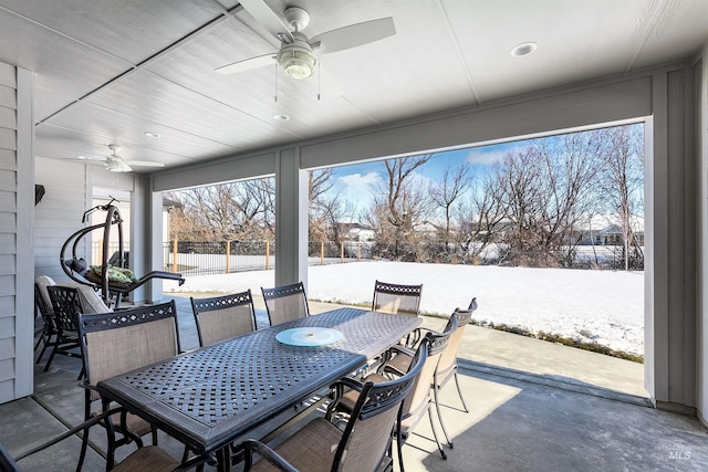 snow covered patio featuring ceiling fan