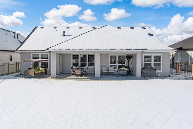 snow covered property featuring a patio area