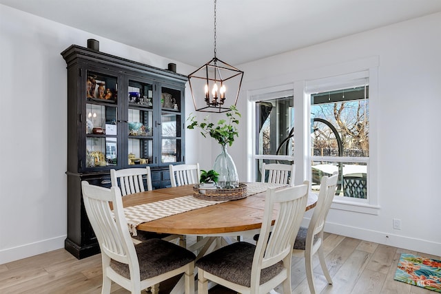 dining room featuring a chandelier and light wood-type flooring