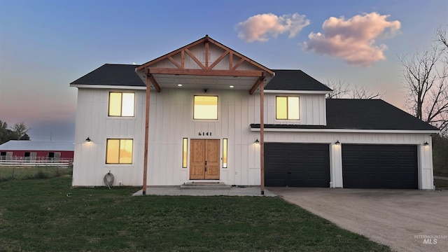 view of front of house with a garage and a yard