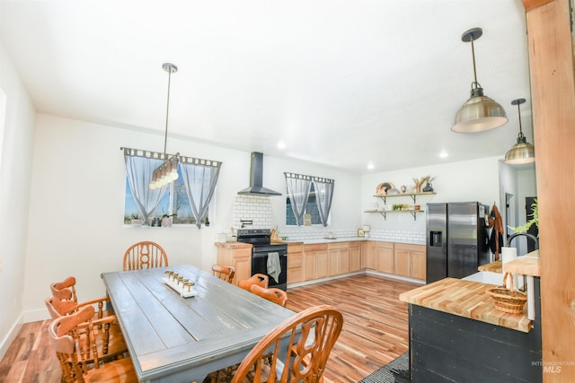 dining space with sink and light hardwood / wood-style floors