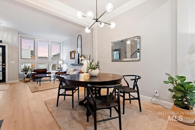 476 E Thurman Mill St, Garden City, ID 83714 - dining room with light wood-type flooring, baseboards, and a notable chandelier