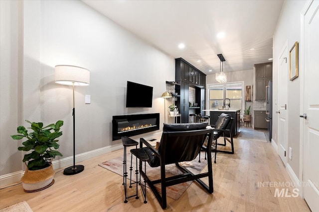 476 E Thurman Mill St, Garden City, ID 83714 - living room with light wood finished floors, baseboards, a glass covered fireplace, and recessed lighting