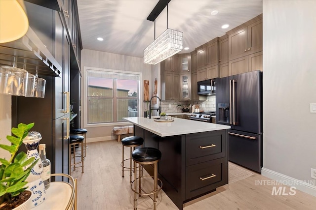 476 E Thurman Mill St, Garden City, ID 83714 - kitchen with a kitchen breakfast bar, black appliances, a kitchen island with sink, light countertops, and a sink