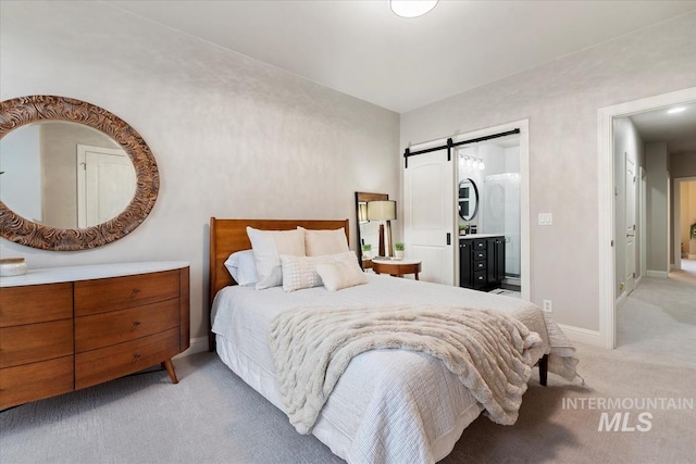 476 E Thurman Mill St, Garden City, ID 83714 - bedroom featuring light carpet, ensuite bathroom, baseboards, and a barn door