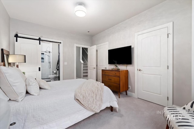476 E Thurman Mill St, Garden City, ID 83714 - bedroom featuring baseboards, connected bathroom, a barn door, and light carpet