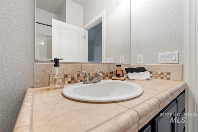 476 E Thurman Mill St, Garden City, ID 83714 - bathroom featuring tasteful backsplash, vanity, and a textured wall