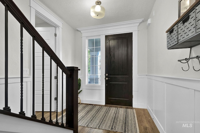 foyer with a textured ceiling and hardwood / wood-style flooring