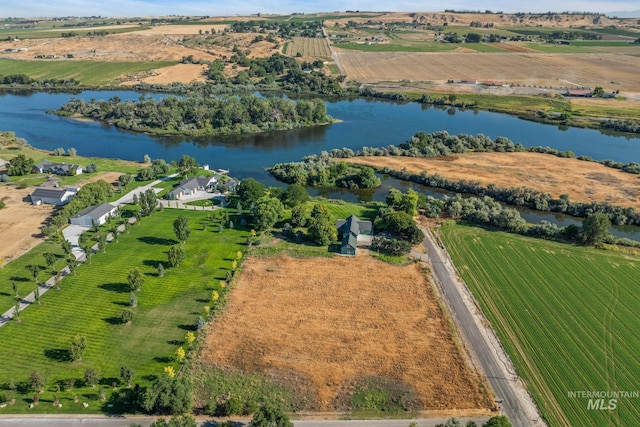 birds eye view of property with a rural view and a water view