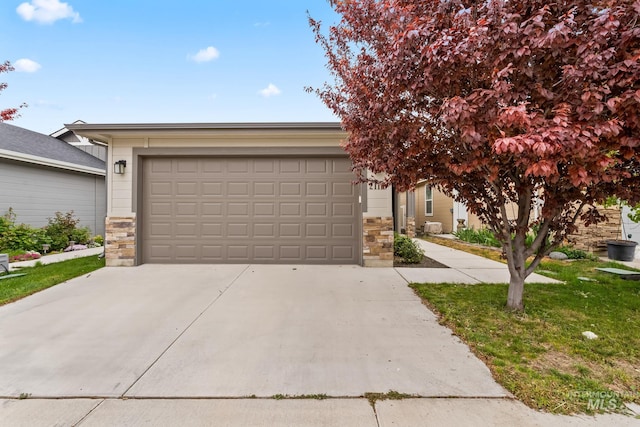 2114 W Claira Rd, Nampa, ID 83651 - view of front facade featuring driveway, stone siding, and a garage