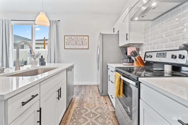2114 W Claira Rd, Nampa, ID 83651 - kitchen featuring a sink, extractor fan, backsplash, light wood-style floors, and appliances with stainless steel finishes