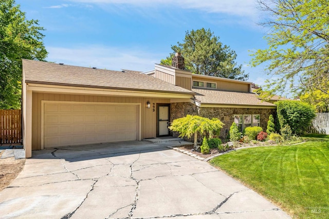 773 Monroe St, Twin Falls, ID 83301 - mid-century modern home featuring stone siding, an attached garage, driveway, roof with shingles, and a chimney
