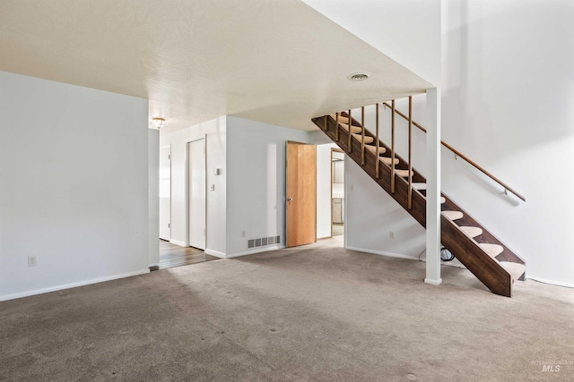 773 Monroe St, Twin Falls, ID 83301 - unfurnished living room with carpet floors, baseboards, and stairway