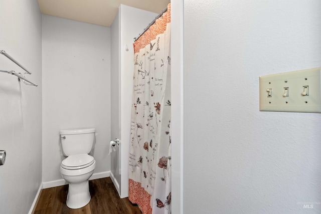 773 Monroe St, Twin Falls, ID 83301 - bathroom with toilet, wood finished floors, baseboards, and a shower with shower curtain