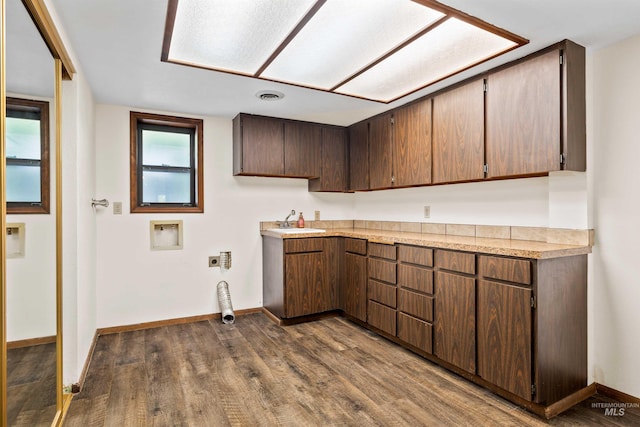 773 Monroe St, Twin Falls, ID 83301 - kitchen with a sink, dark wood-style flooring, light countertops, and baseboards