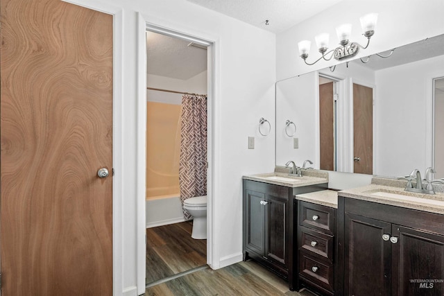 773 Monroe St, Twin Falls, ID 83301 - bathroom with double vanity, wood finished floors, toilet, shower / bath combination with curtain, and baseboards