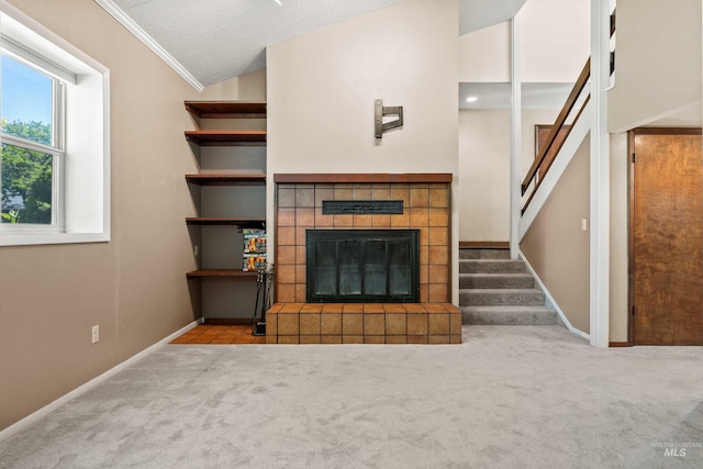 773 Monroe St, Twin Falls, ID 83301 - unfurnished living room with a tiled fireplace, carpet floors, stairs, crown molding, and baseboards