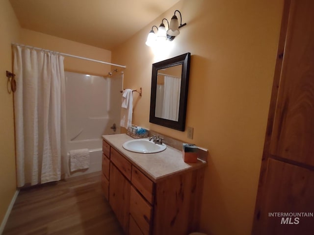 bathroom featuring vanity, hardwood / wood-style floors, and shower / bath combo