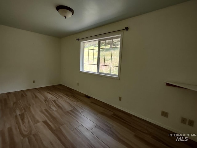 empty room with light hardwood / wood-style floors