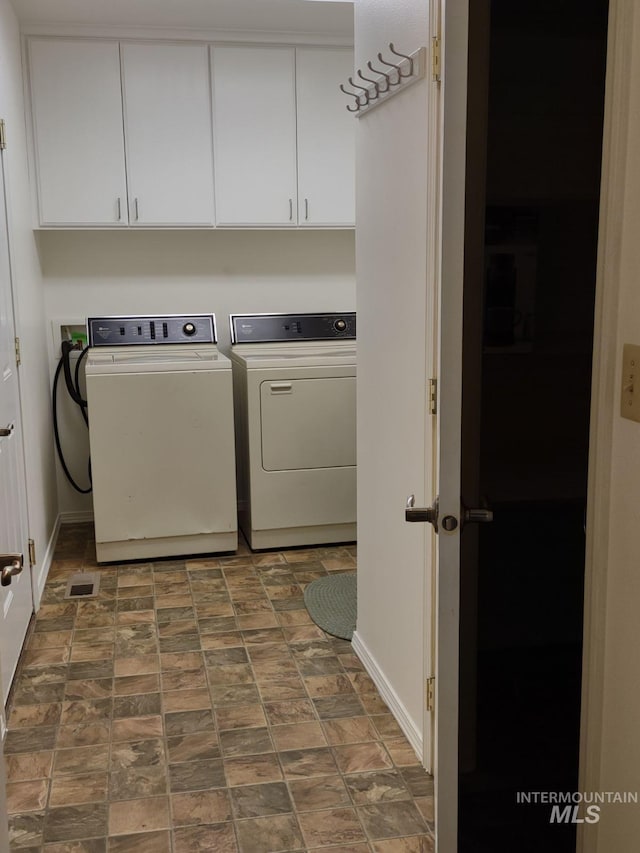 laundry room with cabinets and washer and dryer