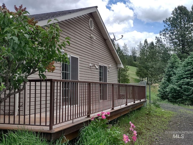 view of side of home with a wooden deck