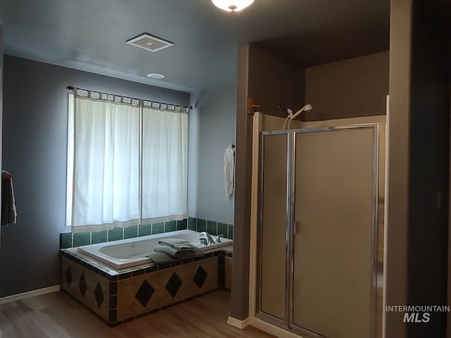 bathroom featuring hardwood / wood-style flooring and independent shower and bath