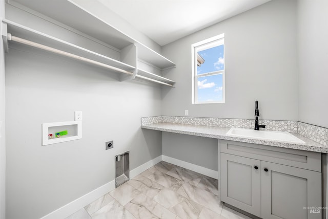 clothes washing area featuring washer hookup, cabinets, sink, and electric dryer hookup